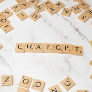 Wooden letter tiles spelling 'ChatGPT' on a marble surface, creating a tech concept image.